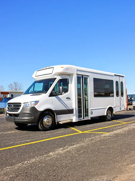 white mini bus parked in a large lot