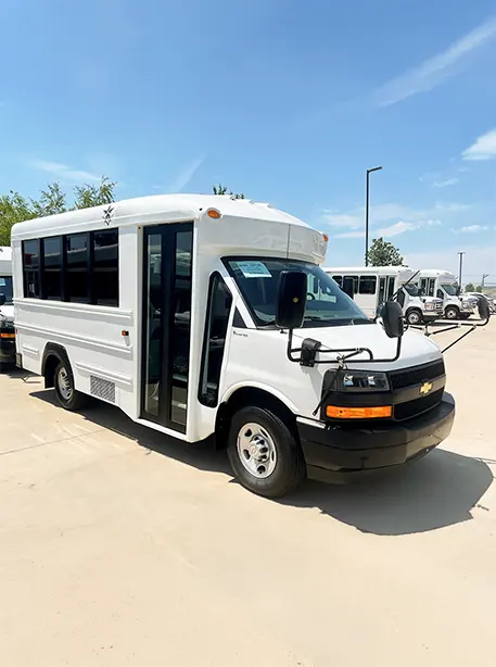 mini bus in white parked in a large lot
