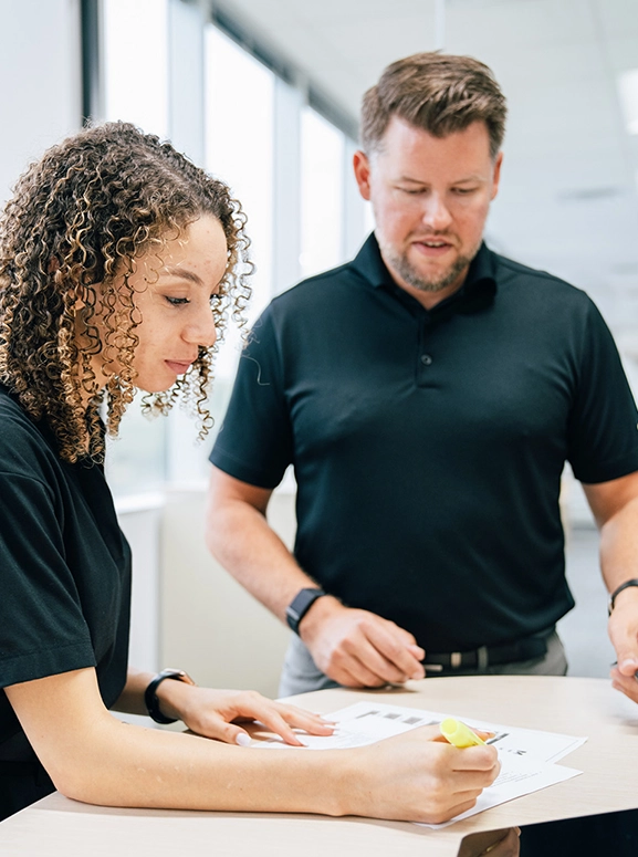 woman and man looking at forms for renting a vehicle in Phoenix